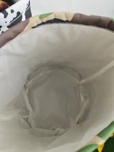 Detailed view of the white interior lining of a camouflage canvas Halloween basket