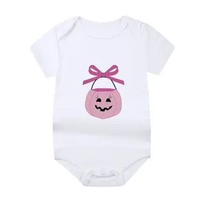 Detailed shot of white newborn baby onesie featuring a pink Halloween pumpkin design.