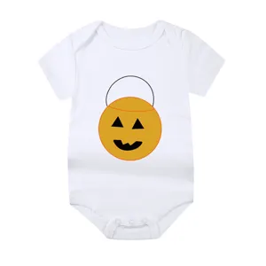 Close-up view of a white newborn baby bodysuit featuring a cute Halloween pumpkin bucket design