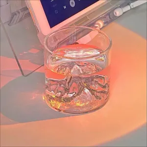 Artistic Mount Fuji whiskey glass featuring a mountain base and warm sunset lighting mood