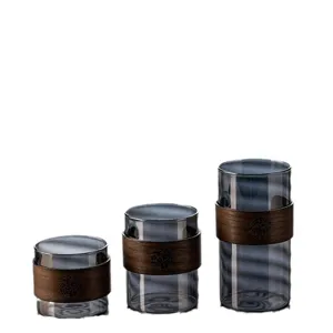Smoky grey heat-resistant glass water cups with wooden insulation rings in three sizes