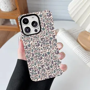 Close-up of leopard pattern printed phone case held by hand for iPhone models