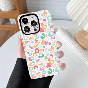 Close-up macro view of a colorful pastel leopard print phone case held by a hand