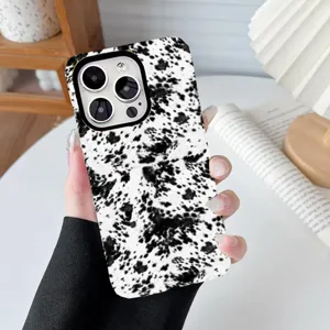 Close-up detail of a fashionable black and white cow print protective phone case