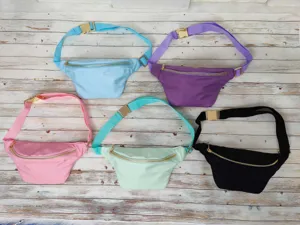 Group view of solid color fanny packs in various colors with adjustable gold metal buckles