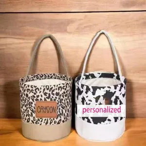 Detailed view of Halloween canvas candy buckets featuring leopard and cow print designs