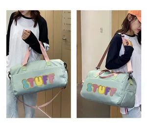 Details of a large capacity mint green sports gym bag with colorful STUFF lettering design