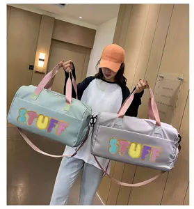 Detailed view of large capacity STUFF letter travel bags in mint green and grey colors