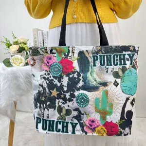 A detailed shot of a large canvas tote bag featuring western-themed punchy prints