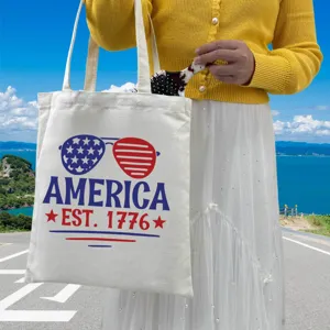 Close-up of canvas tote bag with America Independence Day print in sunny outdoor setting