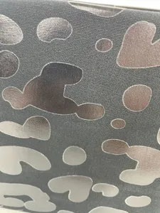 Macro view showing the metallic leopard print texture on high-quality canvas fabric