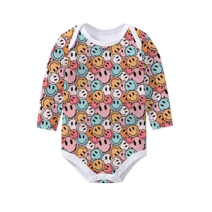 Detailed view of long-sleeve baby bodysuit with colorful retro smiley face print