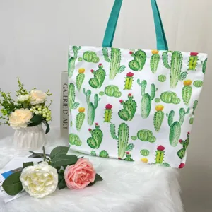 Detailed view of large capacity tote bag featuring vibrant cactus prints and blue straps.