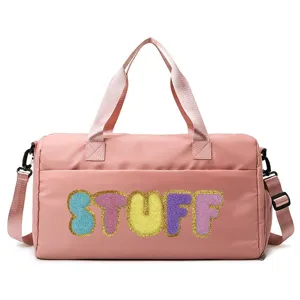 Close-up of a pink large capacity gym bag with colorful chenille STUFF letter embroidery