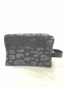 Large capacity leopard print canvas toiletry bag with zipper closure and side handle detail