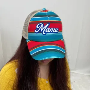 Close-up detail of Mama text print on colorful striped women's ponytail baseball cap