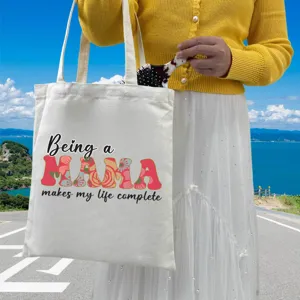 Detail of white canvas tote bag with Being a MAMA makes my life complete floral print