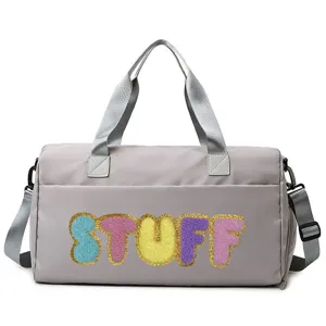 Grey nylon duffle bag featuring colorful chenille STUFF letter patches with glitter borders