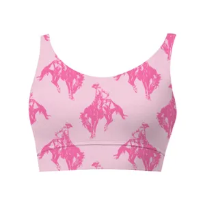 Close-up of pink women's cropped tank top showing repeating cowboy riding print
