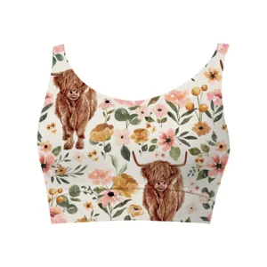 Detailed view of women's crop top featuring highland cow and floral watercolor patterns
