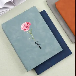 High-quality detail view of A5 soft leather notebook with carnation and custom name print