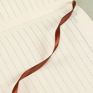 High-quality close-up detail of lined pages with a brown ribbon bookmark in A5 notebook