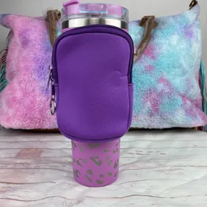Close-up detail of purple neoprene 40oz tumbler sleeve with a zippered storage pouch