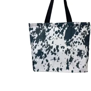 Large capacity canvas tote bag with cow print and black handles for daily commuting use