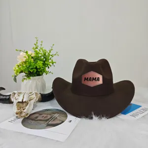 Close-up of brown felt western cowboy hat featuring a 'MAMA' metallic patch design