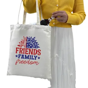Independence Day print canvas tote bag held by a model wearing yellow cardigan