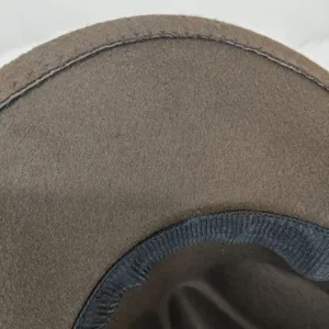 Close-up detail of a brown felt cowboy hat brim and stitching quality.
