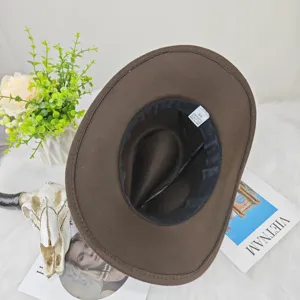 Detail view showing the interior and size tag of a brown western felt cowboy hat