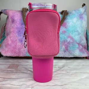 Close-up detail of a pink neoprene phone pouch attached to a 40oz tumbler water bottle