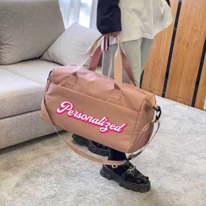 Large capacity pink travel bag with personalized text showing handle and strap detail
