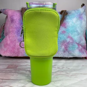 Detailed view of a lime green neoprene accessory pouch attached to a 40oz tumbler