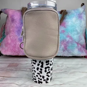 Detail view of khaki neoprene pouch attached to a 40oz leopard print tumbler
