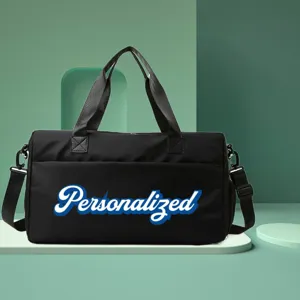 Front view of black gym bag with personalized script text on a green platform.