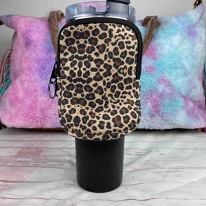 Leopard print neoprene pouch attached to a black 40oz tumbler for essentials storage.