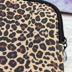 Macro detail of 40oz neoprene cup pouch with trendy leopard print and black zipper.