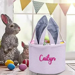Detailed view of striped Easter basket with pink Cailyn embroidery and bunny ears.