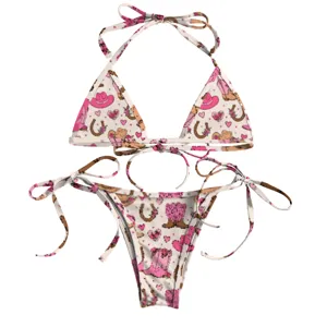 Close-up of a pink cowboy-themed two-piece bikini set featuring boot and hat prints