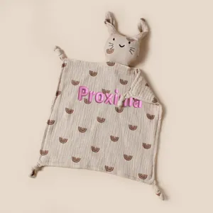 Close-up of personalized pink embroidery on a muslin baby rabbit security blanket