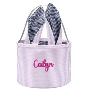Detailed view of personalized Easter bucket with bunny ears and pink Cailyn embroidery.
