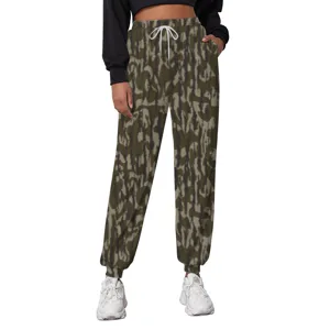 Front view detail of loose camouflage joggers featuring white drawstring and elastic waist