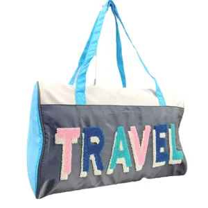 Large capacity travel duffel bag with colorful TRAVEL chenille embroidery on white bg