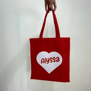 Personalized red canvas tote bag featuring white heart print and Alyssa name detail
