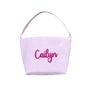 Close-up of personalized embroidered name on pink striped seersucker Easter basket