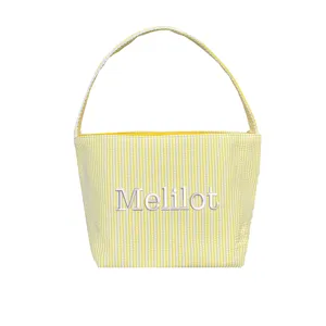 Yellow and white striped seersucker Easter bucket with white Melilot embroidery