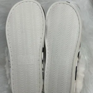 Close-up view of anti-slip wavy pattern on slipper sole with molded size markings