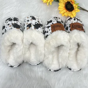 Detail view of customized cow print fuzzy slippers with cozy white faux fur lining